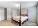 Comfortable bedroom with a four-poster bed, neutral walls and carpet, offering a serene and inviting space at 1133 Streamside Ln, York, SC 29745
