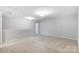 A bright, spacious bonus room featuring neutral carpet and light grey walls is ready for your personal touch at 1133 Streamside Ln, York, SC 29745