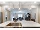 Open kitchen featuring a large island with a sink and pendant lighting that connects to the spacious living room at 1133 Streamside Ln, York, SC 29745