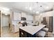 Well-lit kitchen with white cabinetry, a center island, and stainless steel appliances, modern and functional at 1133 Streamside Ln, York, SC 29745