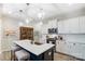 Elegant kitchen with a large island, modern lighting, and stainless steel appliances, perfect for culinary enthusiasts at 1133 Streamside Ln, York, SC 29745