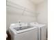 Modern laundry room equipped with Samsung washer and dryer, and overhead wire rack at 1133 Streamside Ln, York, SC 29745