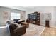Cozy living room featuring comfortable leather seating, a wooden entertainment center, and a stylish area rug at 1133 Streamside Ln, York, SC 29745