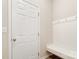 Practical mud room with a bench, hooks and white door at 1133 Streamside Ln, York, SC 29745