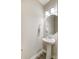 Powder room featuring a pedestal sink, octagonal mirror and neutral decor at 1133 Streamside Ln, York, SC 29745