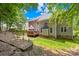 Image shows a backyard with a wooden deck, grassy area, and landscaped garden bed at 122 Laurel Glen Dr, Mooresville, NC 28115