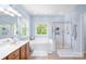 Bathroom featuring a soaking tub and glass-enclosed shower, plus double sinks at 122 Laurel Glen Dr, Mooresville, NC 28115