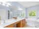 Bathroom with a double sink vanity, soaking tub, and a separate shower at 122 Laurel Glen Dr, Mooresville, NC 28115