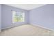 Neutral bedroom with window that lets in natural light at 122 Laurel Glen Dr, Mooresville, NC 28115