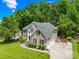 Spacious home featuring a manicured lawn, multi-car garage, and lush landscaping at 122 Laurel Glen Dr, Mooresville, NC 28115
