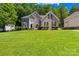 Charming two-story brick home with lush green lawn, landscaped yard, and inviting curb appeal at 122 Laurel Glen Dr, Mooresville, NC 28115