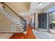 Inviting home foyer with hardwood floors, staircase, and view into an adjacent room at 122 Laurel Glen Dr, Mooresville, NC 28115