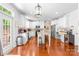 Bright kitchen features white cabinets, island, stainless steel appliances, and hardwood floors at 122 Laurel Glen Dr, Mooresville, NC 28115