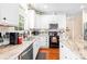 Cozy kitchen featuring white cabinets, granite countertops, and stainless steel appliances at 122 Laurel Glen Dr, Mooresville, NC 28115