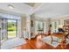 Bright open living room featuring hardwood floors, natural light, and a view of the front yard at 122 Laurel Glen Dr, Mooresville, NC 28115