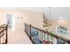 Loft area overlooking the living room with an arched window and wood railing at 122 Laurel Glen Dr, Mooresville, NC 28115