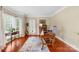 Sunlit office with hardwood floors, large windows, and comfortable workspace at 122 Laurel Glen Dr, Mooresville, NC 28115