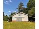 Large grey barn with sliding doors and lean-to shelters at 1243 Cox Mill Rd, Concord, NC 28027
