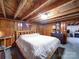 Basement bedroom with a bed, wood-paneled walls, and exposed ceiling, offering a unique and private sleeping space at 1614 Linwood Rd, Gaston, NC 28052