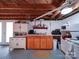 Well-lit basement kitchen with wood cabinets, a white oven, and ample counter space, adding convenience to the lower level at 1614 Linwood Rd, Gaston, NC 28052