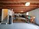 Unfinished basement showcasing exposed wood beams, painted brick, and an open layout, perfect for customization at 1614 Linwood Rd, Gaston, NC 28052
