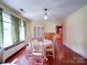 Bright dining room featuring a vintage chandelier, hardwood floors, and classic china cabinet at 1614 Linwood Rd, Gaston, NC 28052