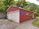 Detached garage with two bays and white doors, providing ample parking and storage with easy access to the property at 1614 Linwood Rd, Gaston, NC 28052