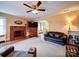 Spacious living room featuring a brick fireplace, plush seating, and an archway leading to the dining area at 1614 Linwood Rd, Gaston, NC 28052