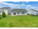Expansive backyard with green lawn, modern gray siding, and well-maintained fencing at 174 Pine Eagle Dr, Rock Hill, SC 29732