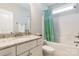 Well-lit bathroom features granite countertop, vanity, tub with shower, and green shower curtain at 174 Pine Eagle Dr, Rock Hill, SC 29732