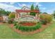 Beautifully landscaped Timberwood community entrance sign with stone accents and vibrant flowers at 174 Pine Eagle Dr, Rock Hill, SC 29732