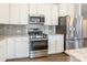 White cabinets, stainless steel appliances, granite countertops, and tile backsplash in kitchen at 174 Pine Eagle Dr, Rock Hill, SC 29732