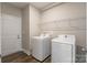 This laundry room showcases modern white machines and convenient shelving for storage at 174 Pine Eagle Dr, Rock Hill, SC 29732
