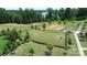 Aerial view of fenced dog park with walking path and lake view at 209 Van Gogh Trl, Mount Holly, NC 28120