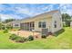 Rear exterior view of home with screened porch and brick patio; includes AC unit at 209 Van Gogh Trl, Mount Holly, NC 28120