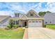 Charming single-Gathering home featuring a two-car garage and manicured landscaping at 209 Van Gogh Trl, Mount Holly, NC 28120