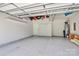 Spacious garage with high ceilings, water heater, and storage shelving at 209 Van Gogh Trl, Mount Holly, NC 28120