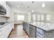 Bright kitchen features stainless steel appliances, granite countertops, and a large island with a sink at 209 Van Gogh Trl, Mount Holly, NC 28120