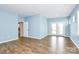 Cozy living room features hardwood floors and a door leading to a small balcony at 209 Van Gogh Trl, Mount Holly, NC 28120