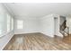 Open living area with multiple windows, neutral paint, and wood flooring at 209 Van Gogh Trl, Mount Holly, NC 28120