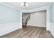 Spacious living room features hardwood floors, white trim, and stairs to the upper level at 209 Van Gogh Trl, Mount Holly, NC 28120