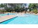 Community pool area featuring zero entry access, seating and lounge chairs at 209 Van Gogh Trl, Mount Holly, NC 28120