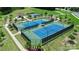 Aerial view of community tennis courts with lake view and landscaping at 209 Van Gogh Trl, Mount Holly, NC 28120