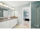 Bathroom boasting a double vanity with granite countertop, framed mirror, and attached bedroom at 2246 Bluebell Way, Fort Mill, SC 29708