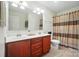 Bathroom features a double sink vanity with cherry cabinets and a shower with a curtain at 2246 Bluebell Way, Fort Mill, SC 29708