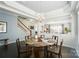 Open dining area with a glass-topped table, decorative chandelier, and seamless flow to the living space at 2246 Bluebell Way, Fort Mill, SC 29708