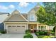 Charming two-story home featuring a manicured lawn, covered porch, and an attached two-car garage at 2246 Bluebell Way, Fort Mill, SC 29708