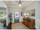 Bright foyer with hardwood floors, stylish console table, mirror and decorative lighting at 2246 Bluebell Way, Fort Mill, SC 29708