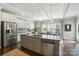 Kitchen island features granite countertops, stainless steel appliances, and connects to a dining area at 2246 Bluebell Way, Fort Mill, SC 29708