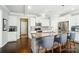 Modern kitchen features white cabinets, stainless steel appliances, a granite countertop island, and seating at 2246 Bluebell Way, Fort Mill, SC 29708